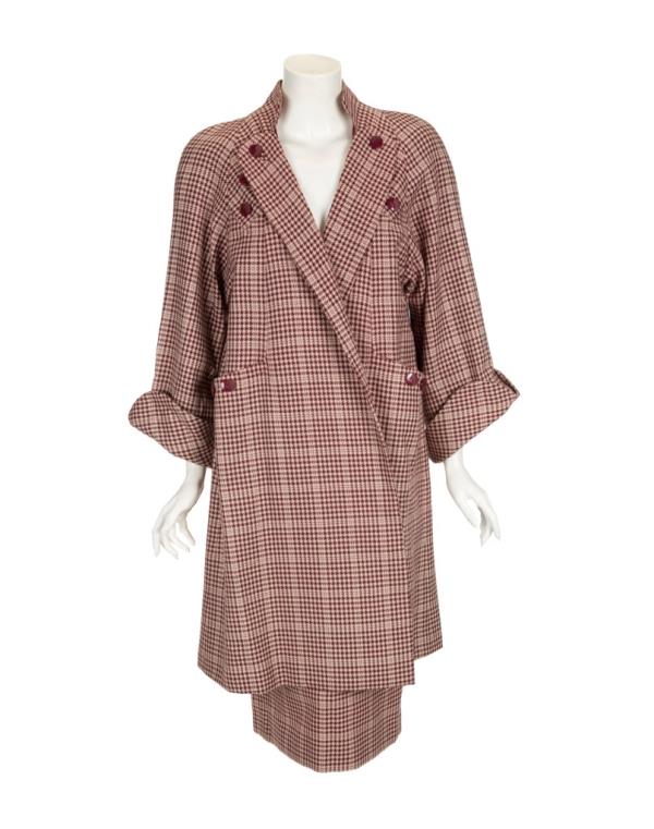 A photo of a burgundy and pale pink houndstooth skirt suit worn by Mado<em></em>nna in her 1996 movie star turn as 