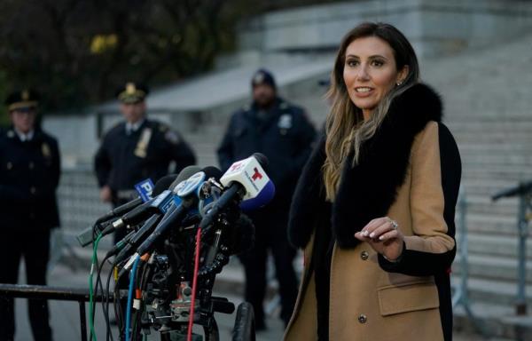 Trump attorney Alina Habba stands next to micropho<em></em>nes outside a courthouse.