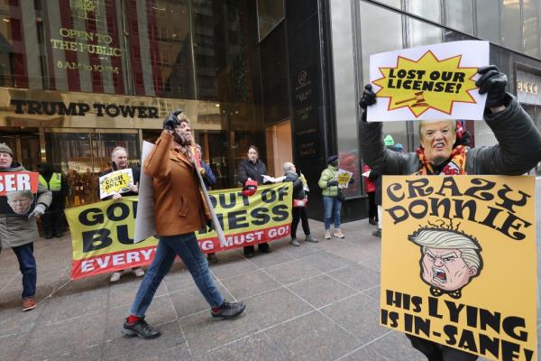 30 protesters with signs in front of Trump Towers in Manhattan, Do<em></em>nald Trump's building. Do<em></em>nald Trump is present.