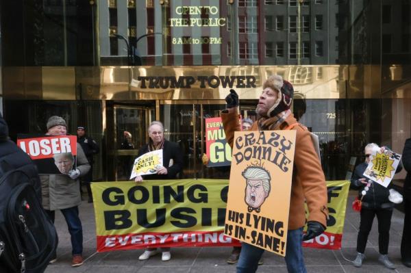 Protesters mock Do<em></em>nald Trump with a going out of business themed rally that partially blocked the entrance of Trump Towers on Feb. 17, 2024. 