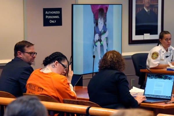 Superior Court Justice Charles Temple holds up a photo of Elijah before explaining his sentence to Dauphinais.