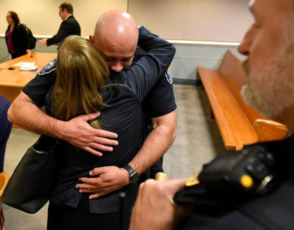 Assistant Attorney General Meghan Hagaman hugs Merrimack Police Chief Brian Levesque following the sentencing.