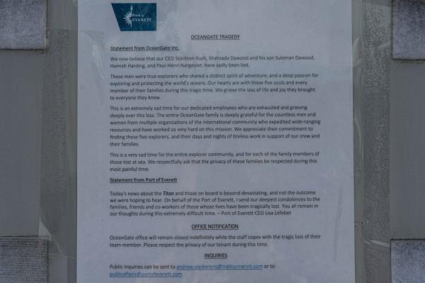 A statement from OceanGate Expeditions is posted to the door of one of the company's locations.