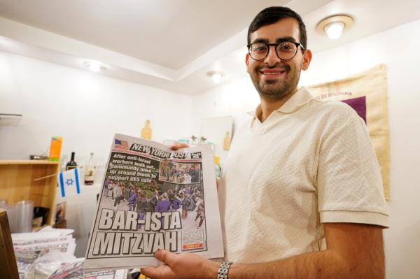 Dahan at this cafe along with the issue of the New York Post from earlier this week detailing his experience.