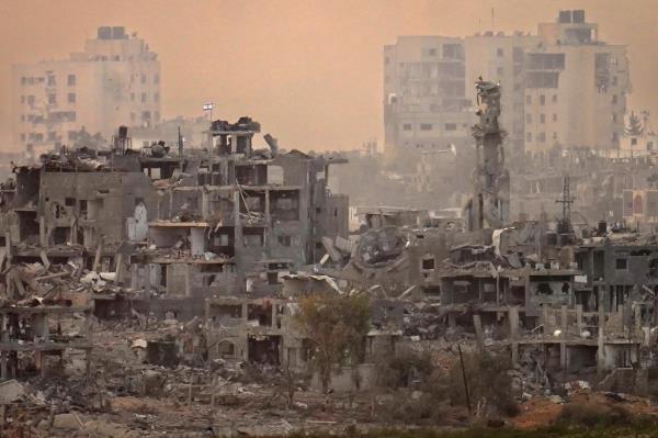 An Israeli flag is seen on top of a destroyed building next to a mosque in northern Gaza on Nov. 13, 2023. 