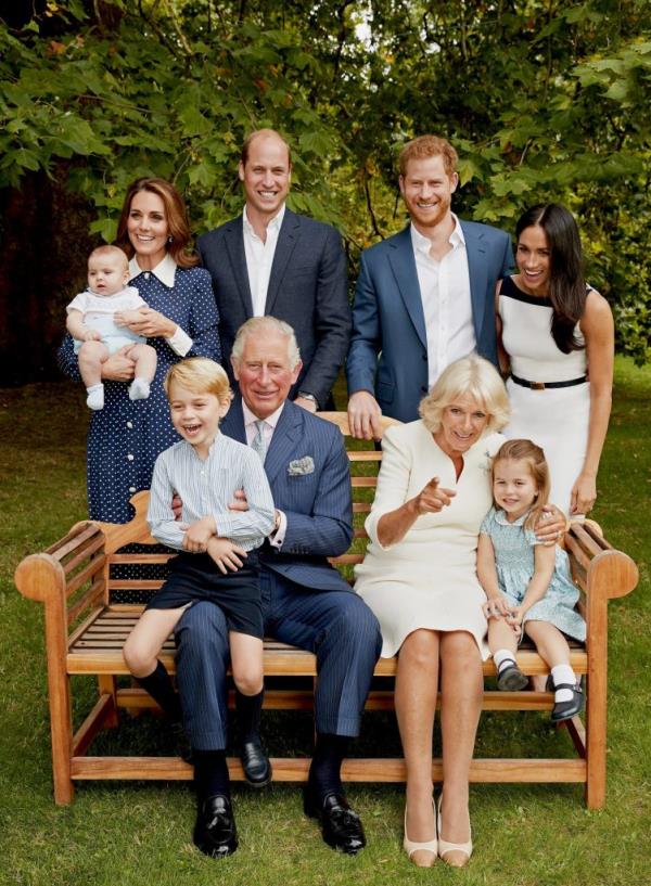 Prince Charles, Prince of Wales, with his family including Camilla, Duchess of Cornwall, Prince William, Catherine, Prince George, Princess Charlotte, Prince Louis, and Meghan, Duke and Duchess of Sussex, posing for a portrait in Clarence House gardens.