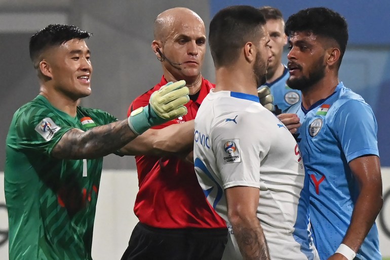 Al-Hilal SFC's forward Aleksandar Mitrovic (C) and Mumbai City FC's goalkeeper Phurba Tempa Lachenpa (L) tussel during the AFC Champions League 2023/24 Group D football match between India's Mumbai City FC and Saudi Arabia?s Al-Hilal SFC at the D.Y. Patil stadium in Navi Mumbai on November 6, 2023. (Photo by AFP)