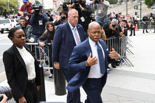 Mayor Eric Adams enters a federal courthouse.