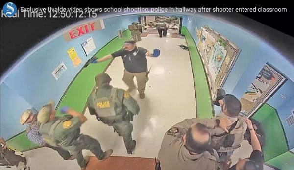 In this photo from surveillance video provided by the Uvalde Co<em></em>nsolidated Independent School District, authorities respond to the shooting at Robb Elementary School in Uvalde, Texas on May 24, 2022. 