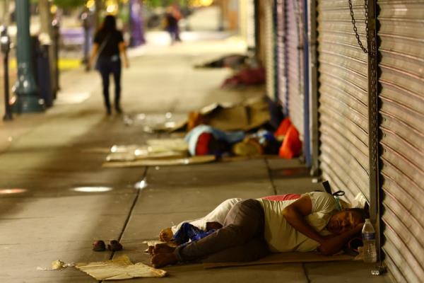 Migrants sleep on the street after being released from U.S. Border Patrol custody in downtown El Paso.