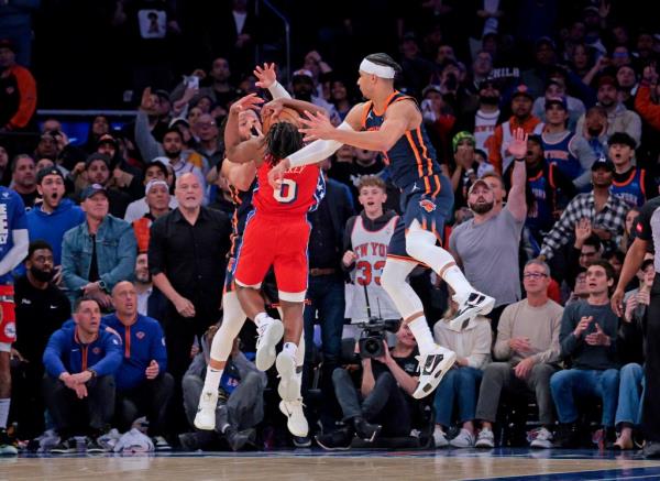 Jalen Brunson and Josh Hart defend Tyrese Maxey.