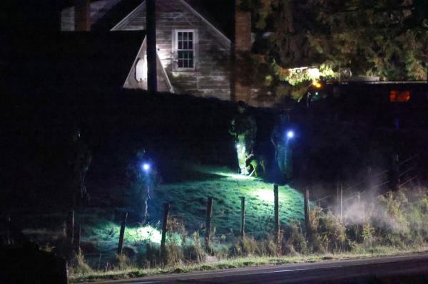 Law Enforcement officials search an area for a suspect in co<em></em>nnection with two mass shootings on October 26, 2023 in Bowdoin, Maine.