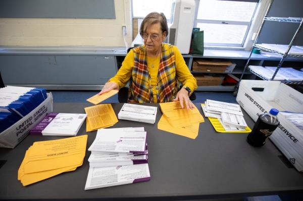 Election worker Julie Fox preparing absentee ballots at the Reo Elections Office in Lansing, Michigan for the upcoming Presidential election