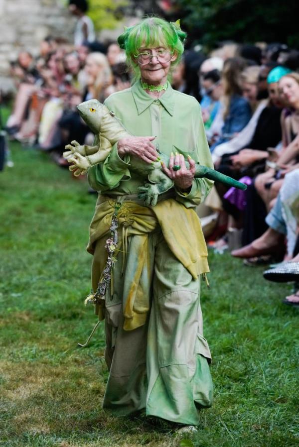 Model holding a lizard on the runway at the Collina Strada RTW Spring 2025 event, part of New York Fashion Week held at the Marble Cemetery