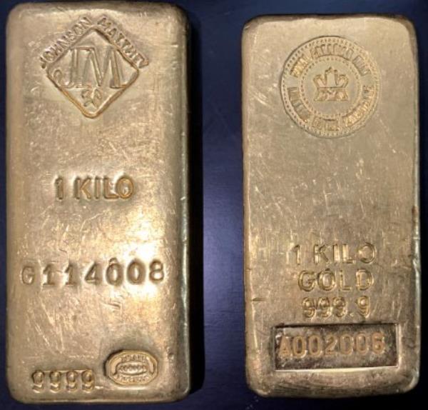 Two gold bars marked (left) 1 kilo, G114008, and (right) 1 kilo gold 9999