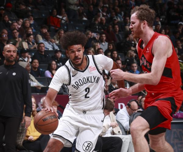 Cam Johnson drives to the basket during the Nets' preseason loss to the Raptors.
