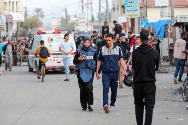 Khawla and her husband Baher walk back after she finishes work