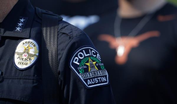 Members of the Austin police department and University of Texas football team march in protest to the State Capitol in Austin.