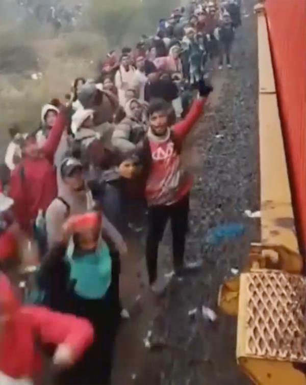 The massive line of migrants disappeared around the curve of the train tracks