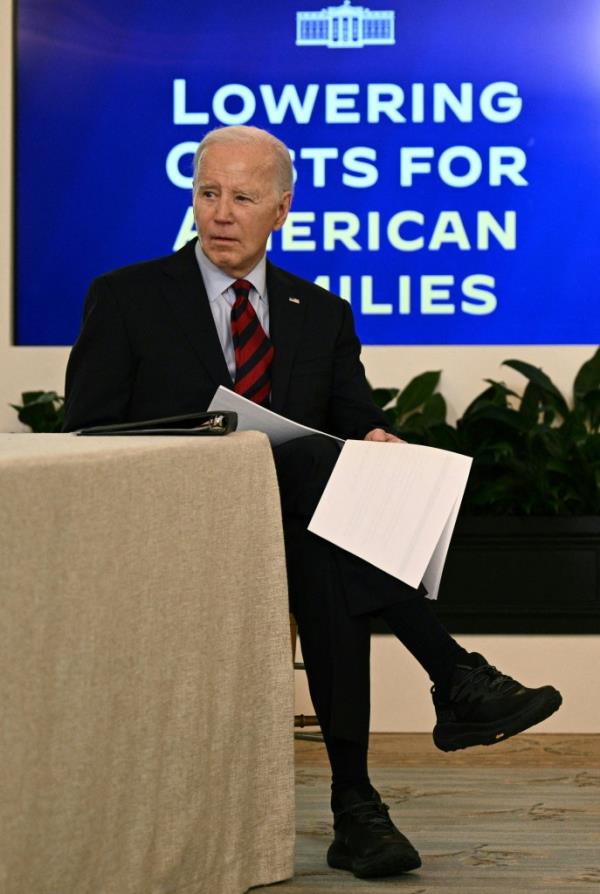 Joe Biden sitting at a table with papers.