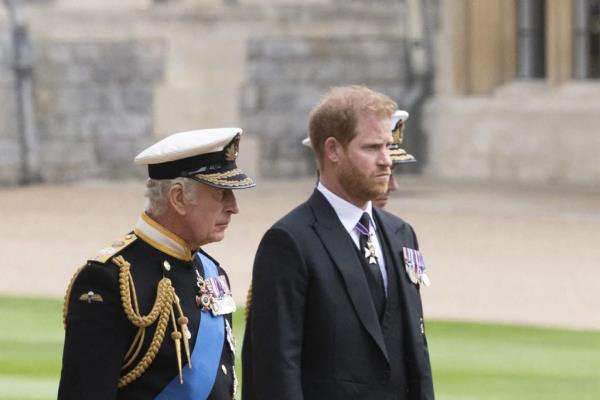 King Charles III and Prince Harry, Duke of Sussex walking together at St George's Chapel, Windsor Castle ahead of Queen Elizabeth II's Committal Service