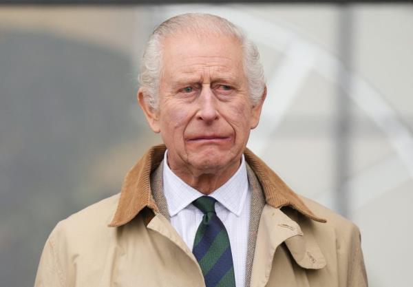 King Charles III attending day three of the Royal Windsor Horse Show at Windsor Castle in a trench coat