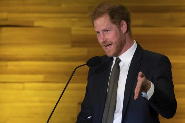 Prince Harry, Duke of Sussex, speaking into a microphone at the 'One Year to Go' Invictus Games dinner in Vancouver, British Columbia