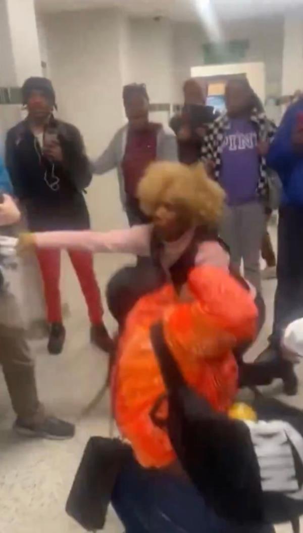The teacher is pictured stumbling after the fight.