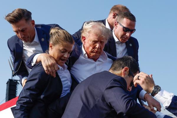 Former President Do<em></em>nald Trump being rushed offstage by Secret Service agents at a rally in Butler, Pennsylvania after being grazed by a bullet