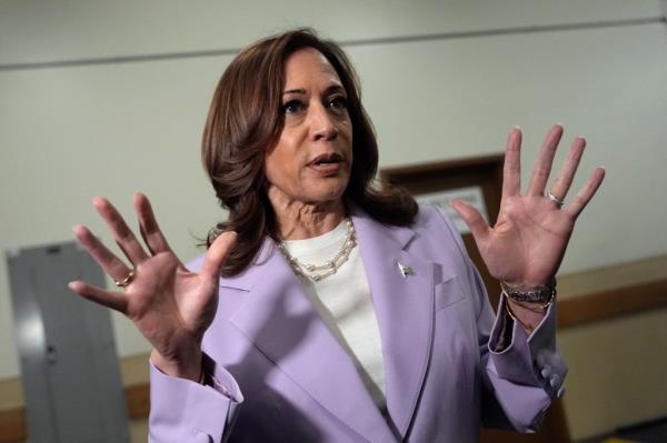 US Vice President Kamala Harris delivering a speech at the Sheraton hotel in Phoenix, Arizona in a purple suit on August 10, 2024.