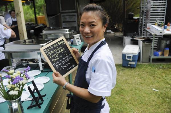 Top Chef co<em></em>ntestant Shirley Chung holding a chalkboard in episode 1108, titled 'Pigging Out'
