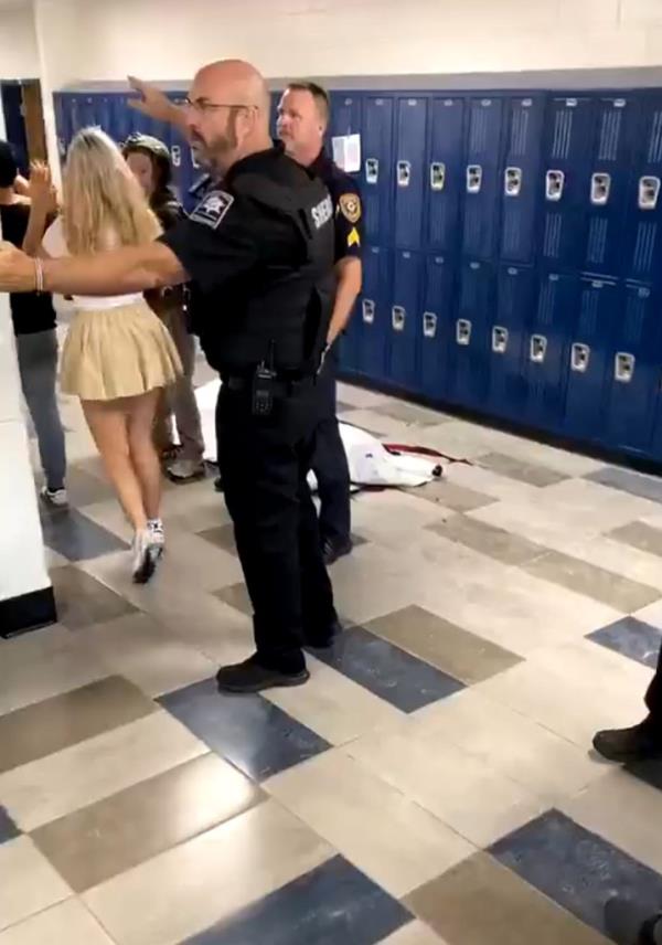 Terrified students were evacuated through a hallway – and walked past a body covered in a white sheet.