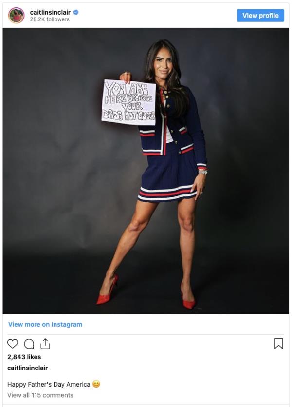 A co<em></em>nservative journalist holding a co<em></em>ntroversial sign in a posh members-o<em></em>nly nightclub