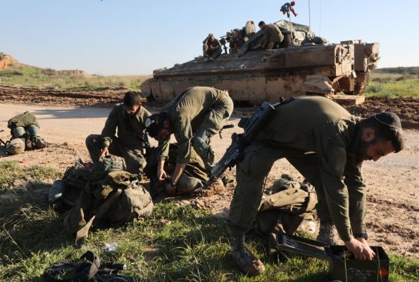 Israeli soldiers are seen near the border by Gaza strip, in southern Israel, on Feb. 8, 2024. 