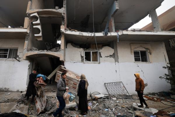 People salvage some belo<em></em>ngings from the rubble of a destroyed building, in the aftermath of Israeli bombardment on Rafah in the southern Gaza Strip on Feb. 9, 2024. 