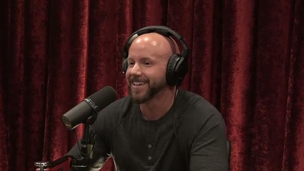 Brigham Buhler, wearing headpho<em></em>nes and sitting in front of a microphone, on a podcast hosted by Joe Rogan