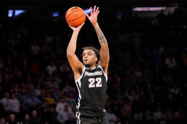 Providence guard Devin Carter shoots from 3-point range during the second half of the team's NCAA college basketball game against Marquette in the semifinals of the Big East men's tournament.