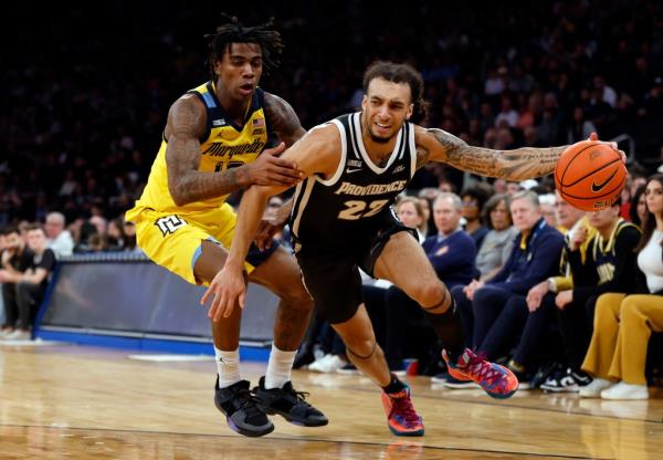 Devin Carter #22 of the Providence Friars dribbles against Zaide Lowery #10 of the Marquette Golden Eagles in the first half during the Semifinal round of the Big East Basketball Tournament at Madison Square Garden.