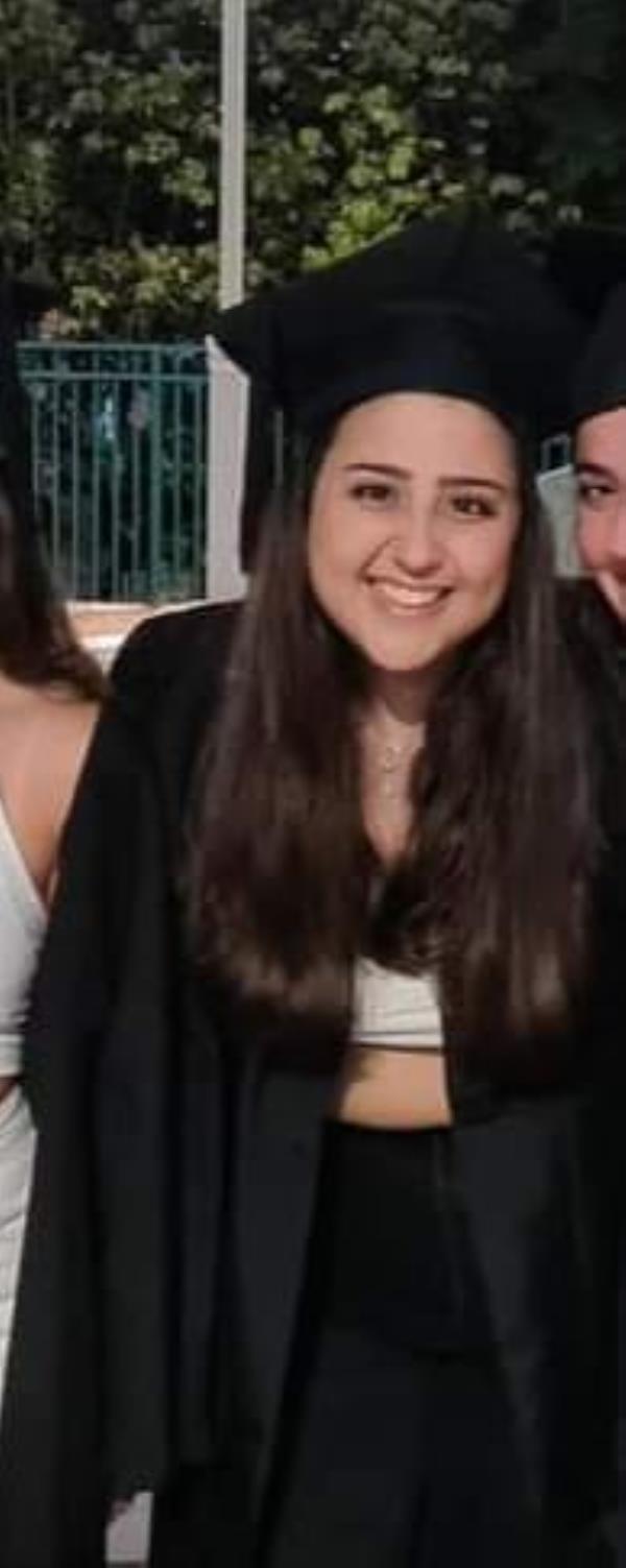 Eshel in a graduation gown. 