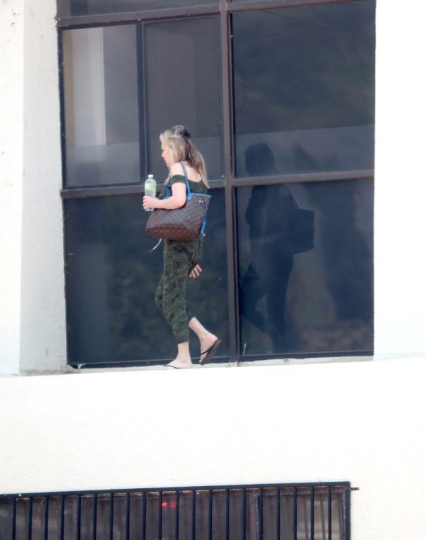 Heather Locklear sparks major fears for her perso<em></em>nal safety as she is seen precariously balancing herself along the edge of a tall office building whilst appearing to be in some sort of distress.