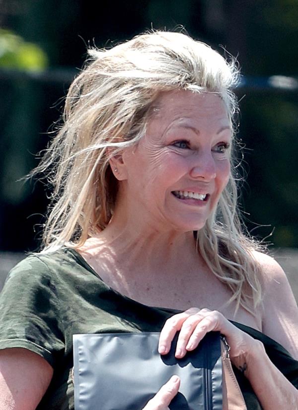 Heather Locklear sparks major fears for her perso<em></em>nal safety as she is seen precariously balancing herself along the edge of a tall office building whilst appearing to be in some sort of distress.