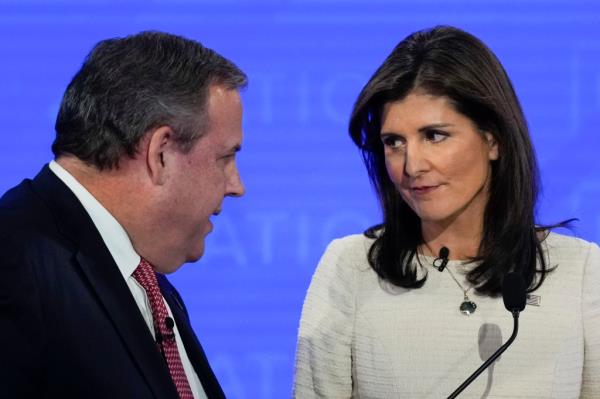 Former New Jersey Gov. Chris Christie, left, and former U.N. Ambassador Nikki Haley, right, talk during a commercial break at a Republican presidential primary debate