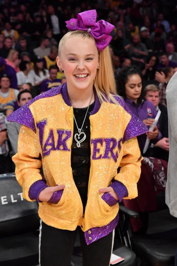 JoJo Siwa smiling at the camera while attending a Los Angeles Lakers vs. Phoenix Suns basketball game at Staples Center, Los Angeles, California, February 10, 2020