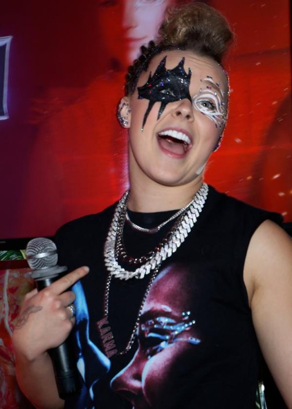 Jojo Siwa promoting her new hit 'Karma' at a West Hollywood event wearing a black mask with rhinestones
