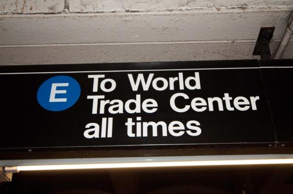 A sign for the Manhattan-bound E train inside an NYC subway station.