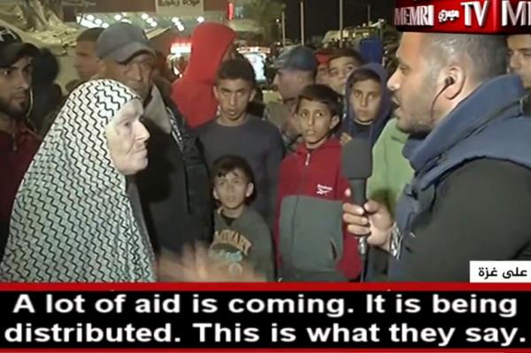 The reporter spoke to the woman as others looked on. 