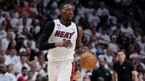 Miami Heat center Bam Adebayo (13) dribbles the ball during the first half of Game 3 of the NBA Finals basketball game against the Denver Nuggets, Wednesday, June 7, 2023