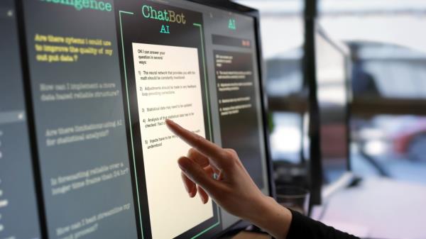 A hand is raised to a computer screen with a window open called 