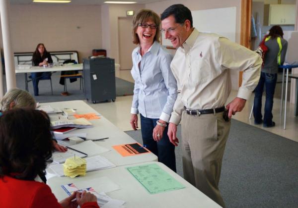 U.S. Sen. John Barrasso, right, and his wife Bobbi Barrasso laugh with election judges before voting in the general election, Nov. 6, 2012 at St. Stephen's Episcopal Church in Casper, Wyo.