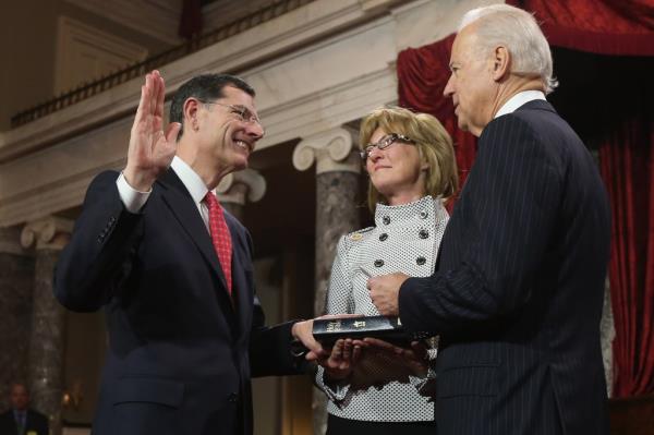 U.S. Sen. John Barrasso (R-WY) (L) participates in a reenacted swearing-in with his wife Bobbi Brown and U.S. Vice President Joe Biden in the Old Senate Chamber at the U.S. Capitol  January 3, 2013 in Washington, DC.